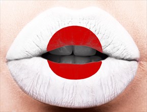 Female lips close up with a picture of the flag of Japan. Red circle