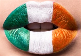 Female lips close up with a picture flag of Ireland. Green