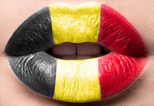 Female lips close up with a picture of the flag of Belgium. black