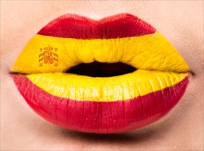 Female lips close up with a picture of the flag of Spain. red
