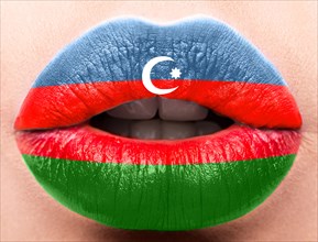 Female lips close up with a picture of the flag of Azerbaijan. Blue