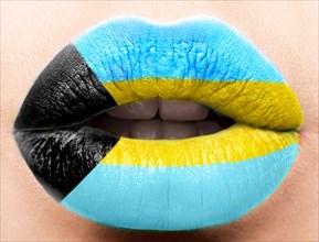 Female lips close up with a picture of the flag of Bagamy