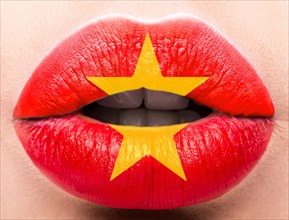 Female lips close up with a picture of the flag of Vietnam. Red