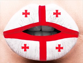 Female lips close up with a picture of the flag of Georgia. white