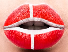 Female lips close up with a picture of the flag of Denmark. white