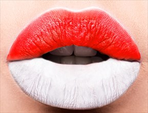 Female lips close up with a picture of the flag of Indonesia. white