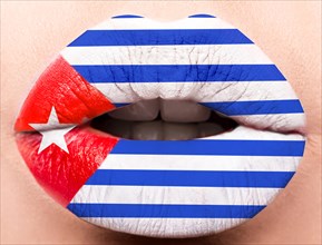 Female lips close up with a picture of the flag of Cuba. white
