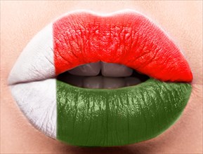 Female lips close up with a picture of the flag of Madagascar. red