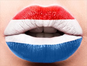 Female lips close up with a picture of the flag of Netherlands. Blue