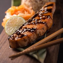 Teriyaki salmon with rice on a wooden platter. Top view. Photo shot in studio