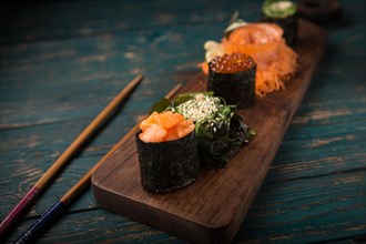 Sushi set on a wooden tray. Photo shot in studio