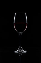 Red wine in a glass isolated on black background