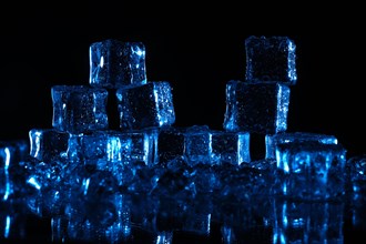 Transparent cold ice cubes on a black background