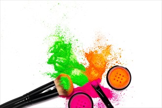 Cheek brush with neon cosmetic powder colorful pile and isolated on white background