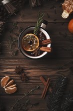 Christmas hot drink mulled wine on wooden background with cinnamon