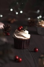 Christmas cakes on wooden background with new year garlands