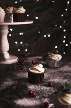Christmas cakes on wooden background with new year garlands