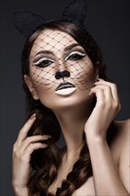 Beautiful girl in the image of a cat with art make-up and lace ears. beauty face. Photos shot in the studio