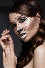 Beautiful girl in the image of a cat with art make-up and lace ears. beauty face. Photos shot in the studio