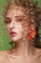 Beautiful blonde girl with curls and gentle make-up. Beauty face. Photos shot in the studio