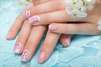 Spring manicure for the bride in gentle tones with flowers. Nail Design