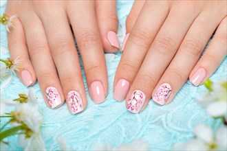 Spring manicure for the bride in gentle tones with flowers. Nail Design