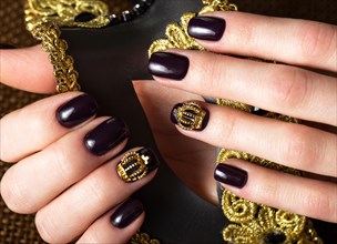 Black female manicure nails closeup with crown