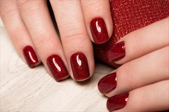 Bright festive red manicure on female hands. Nails design