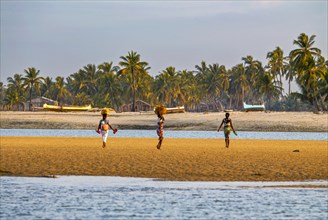 Local women walking on the beach of Morondave