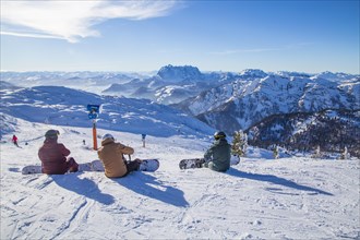 Snowboarders resting at the summit