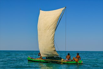 Traditional sailing boat and rowing boat in the turquoise water of the Indian Ocean