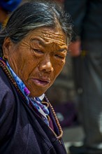 Old tibetan woman before the Jokhang temple