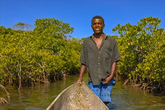 Man paddling through the mangroves of the Island Ile Sainte-Marie although Nosy Boraha