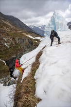 Exercise crevasse rescue for ski touring on a cliff