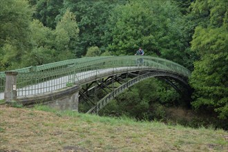Historic arched bridge with cyclist over the Werra
