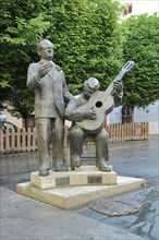 Two musicians sculpture in duet with singer and guitarist at the Plaza de la Soledad in Badajoz