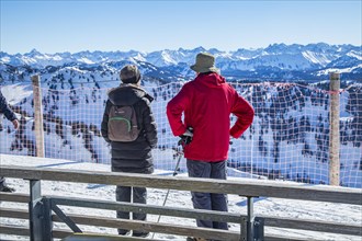 Senior holidaymaker couple admires mountain panorama