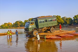 Truck crossing on a improvised ferry the Manambolo river