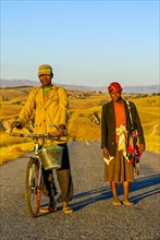 Local couple walking home at sunset on the road between Antanarivo and Morondavia