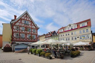 Market place with street pub and half-timbered house