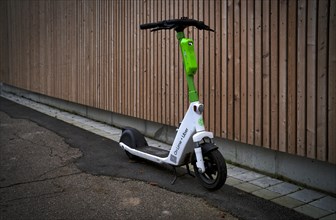 E-scooter parked on the side of the road in the bike rental of the company Lime