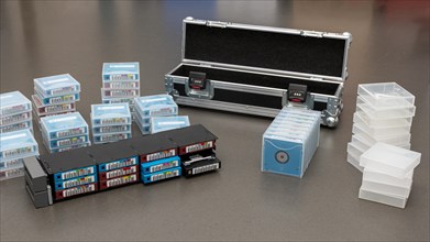 Data backup magnetic tapes lie next to a lockable transport case