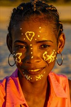 Pretty young girl with little paintings in her face