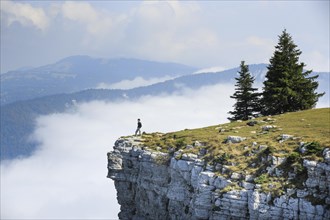 Man standing on the edge of the Creux du Van