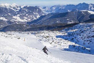Skiers in the terrain above the Steinberg downhill run