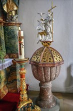 Baptismal font with candle