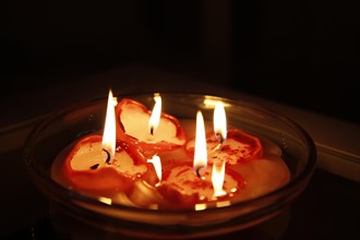 Burning candles in a bowl