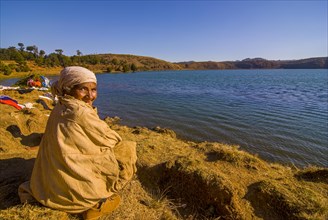 Old woman sitting on Lac Andraikiba