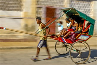 Man running with his walking rickshaw