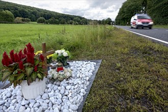 Memorial with cross for victims of road accident on country road